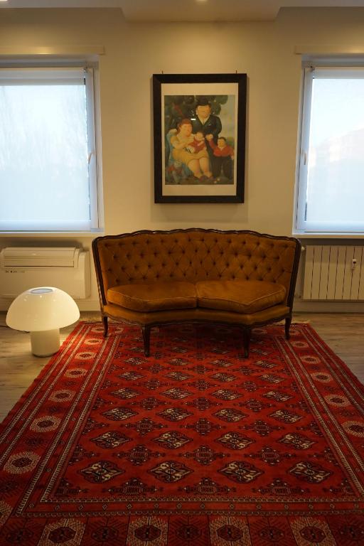 a couch in a living room with two windows at APARTMENT ON THE SQUARE in Rome