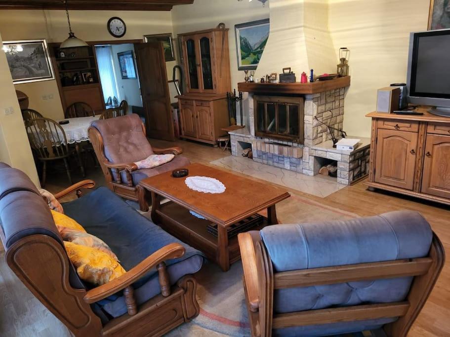 a living room with a couch and a table and a fireplace at dar diyafa in Kreševo