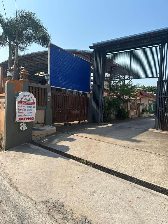 a building with a large gate and a sign at EKALUK PLACE INN in Pattaya North