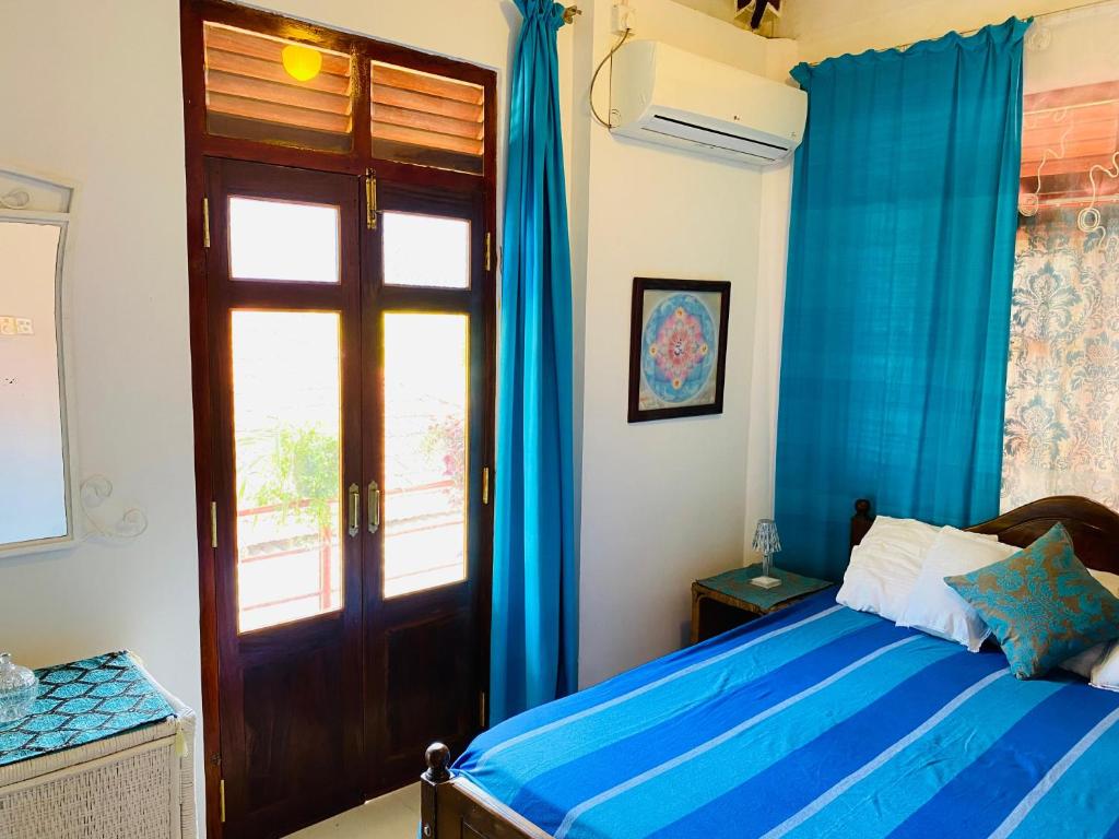 A bed or beds in a room at Ganga Villa