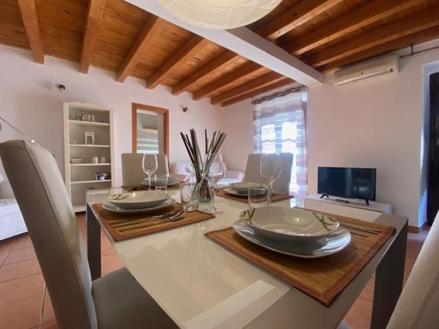 a dining room with a table with plates on it at Montesanto 13 in Palermo