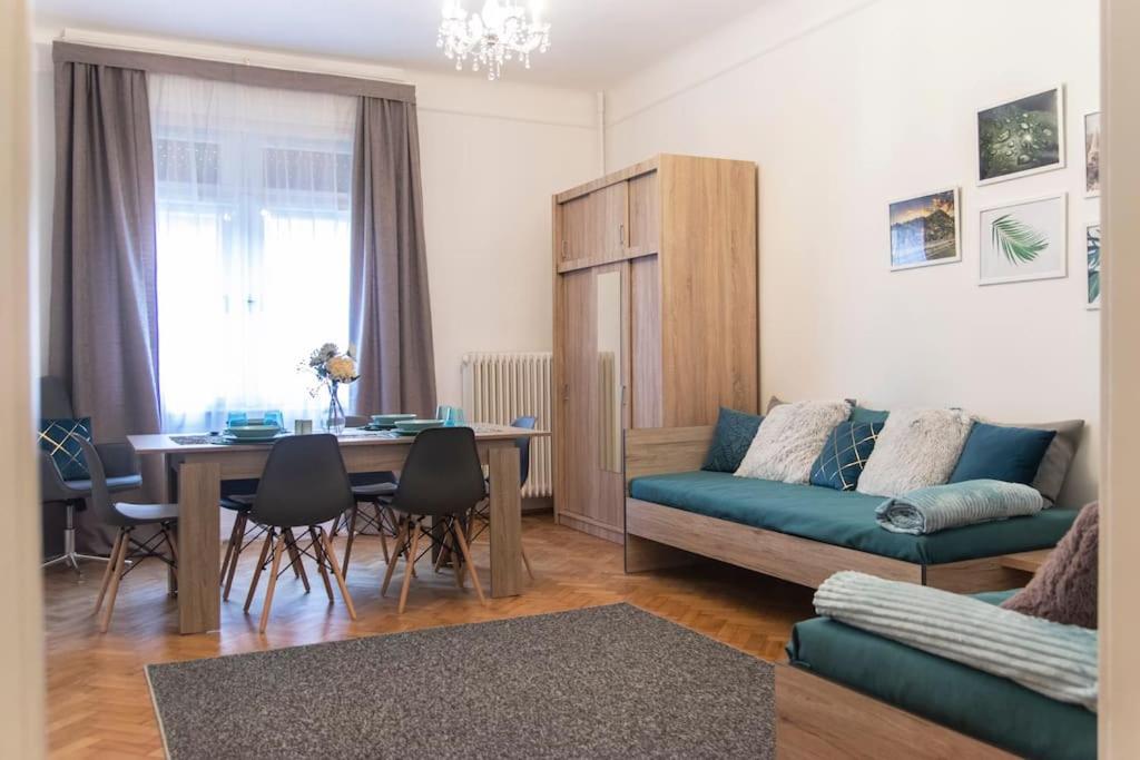 a living room with a couch and a table at Central Buda Comfort in Budapest