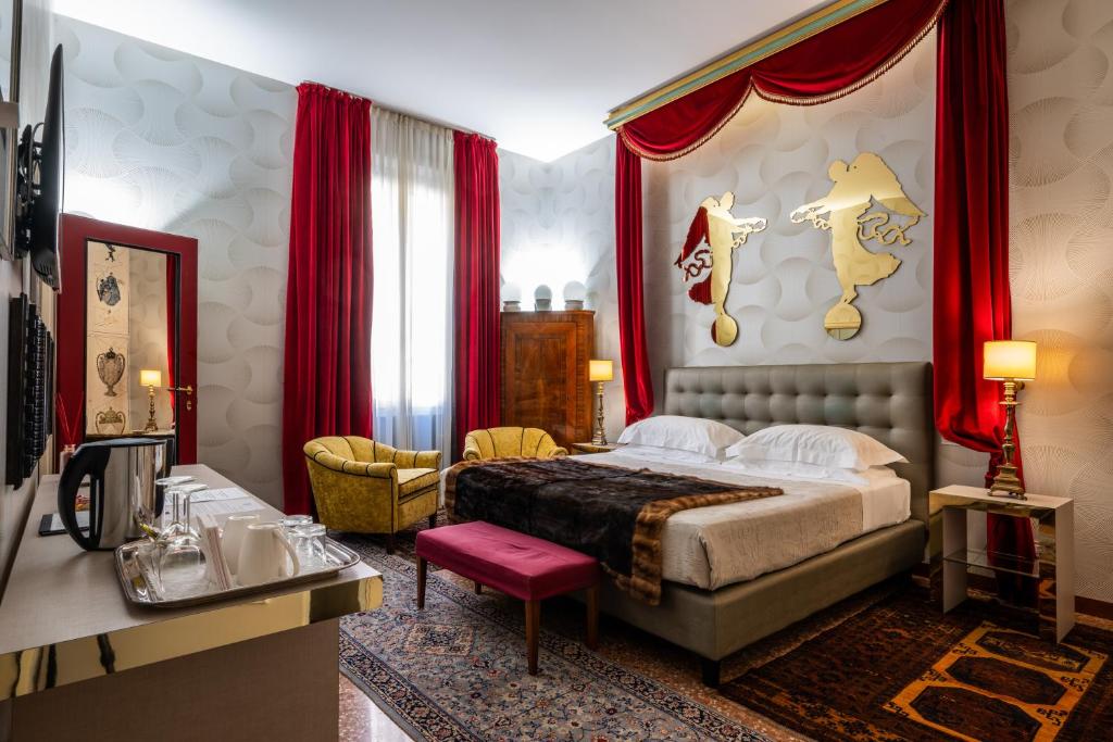 a bedroom with a king sized bed and red curtains at Casa Bertagni in Bologna