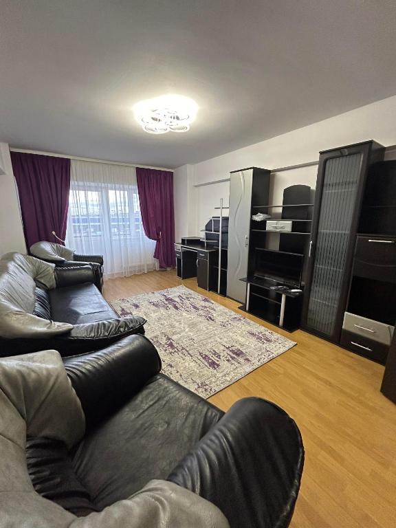 a living room with two couches and a television at Apartament de 3 camere zona Obcini in Suceava
