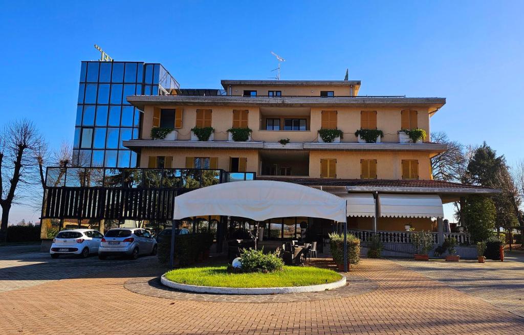 un edificio con una tienda blanca delante de él en HOTEL AI TIGLI, en Langhirano