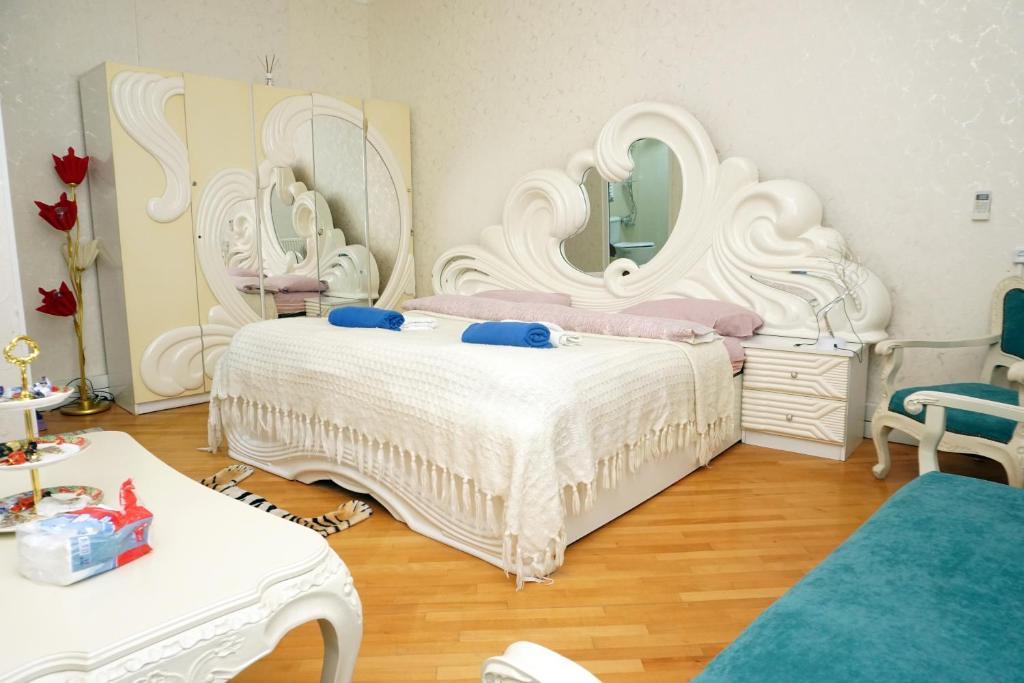 um quarto com uma grande cama branca e um grande espelho. em Belas House With Terrace em Kutaisi