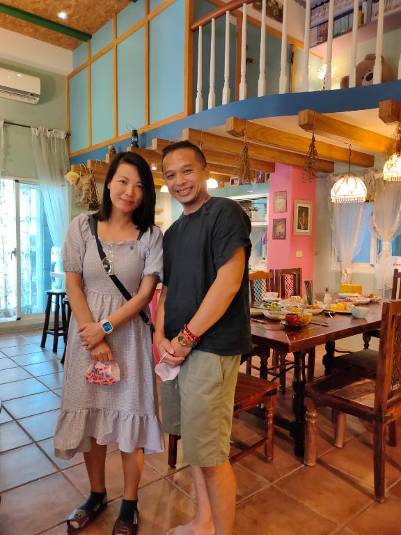 a man and a woman standing in a room at Happiness B&amp;B in Luodong