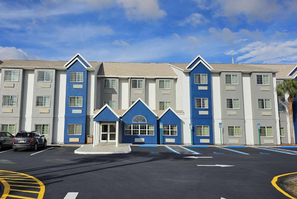 a large blue and white building with a parking lot at Microtel Inn & Suites by Wyndham Bushnell in Bushnell