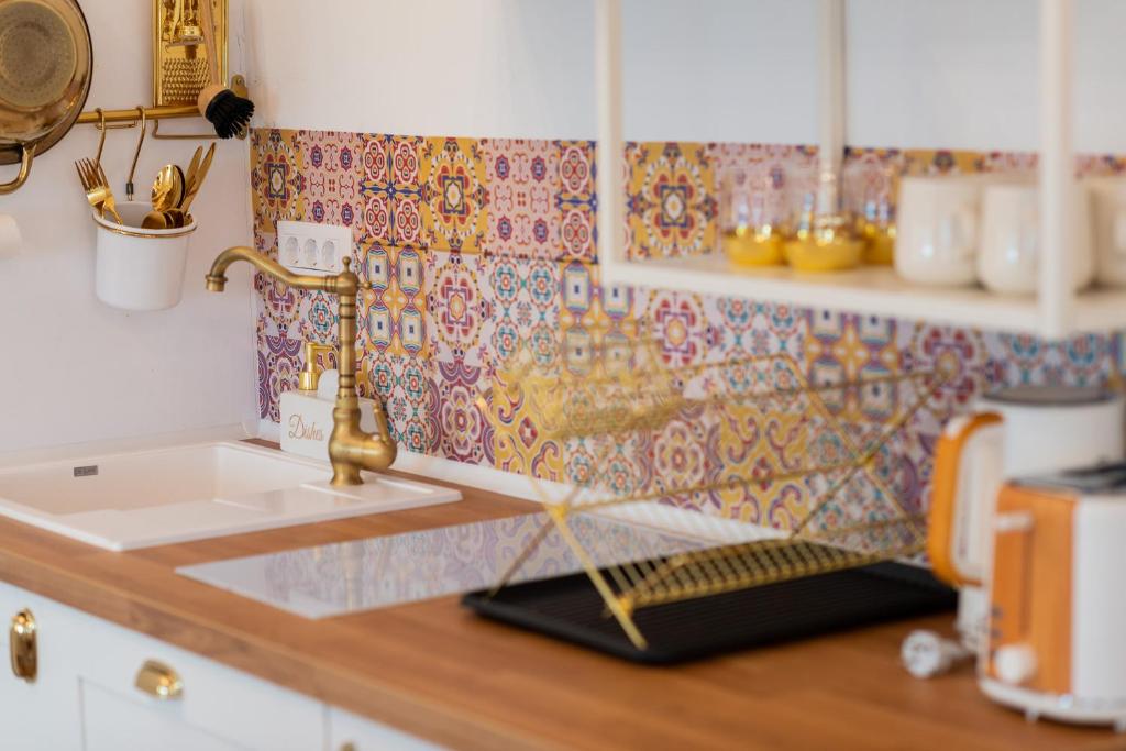 a kitchen with a sink and a counter top with a counter top at Fernweh Haus Brasov in Braşov