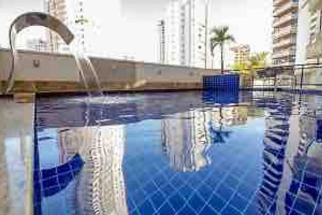 a swimming pool with a fountain in a city at Sun Square Marista Vista Pça do Sol! Hospitais,mercados e cartórios, tudo perto! 301 in Goiânia