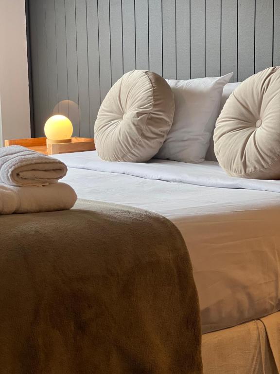 a bed with two pillows on top of it at Seaport Apartments STUDIO Rivadavia H in Ushuaia