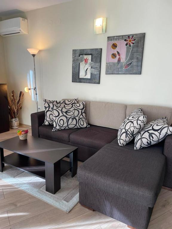 a living room with a couch and a coffee table at Apartament Ivanovi A119 in Burgas