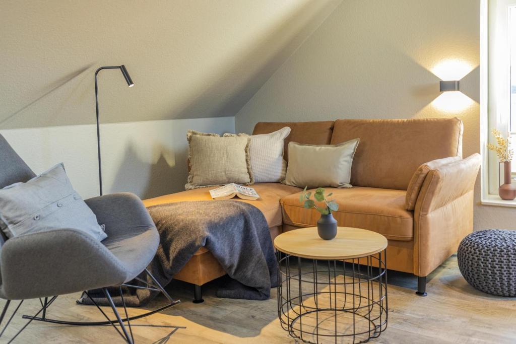 a living room with a couch and two chairs at Pier17 Appartement 6 in Borkum