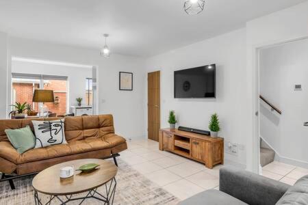 a living room with a couch and a table at 2 bedroom house NE Norwich in Norwich