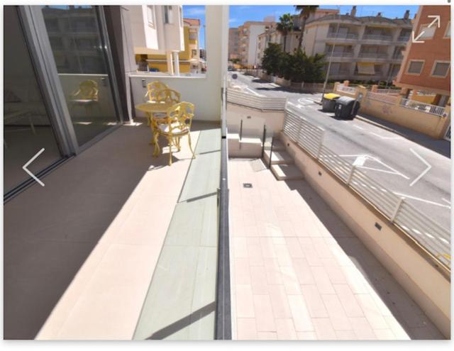 a balcony with a table and chairs on a building at Santa Pola in Santa Pola