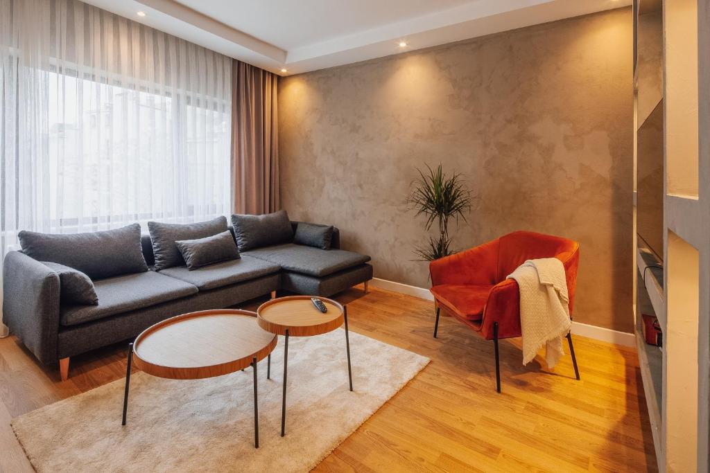 a living room with a couch and two tables at Uraya Suites in Istanbul