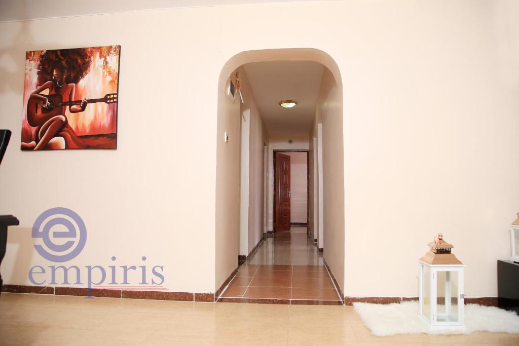 a hallway in a house with a painting on the wall at 1BR Luxury Apartment Milimani Nakuru, Empiris with Pool, Gym, Near Golf Club in Nakuru
