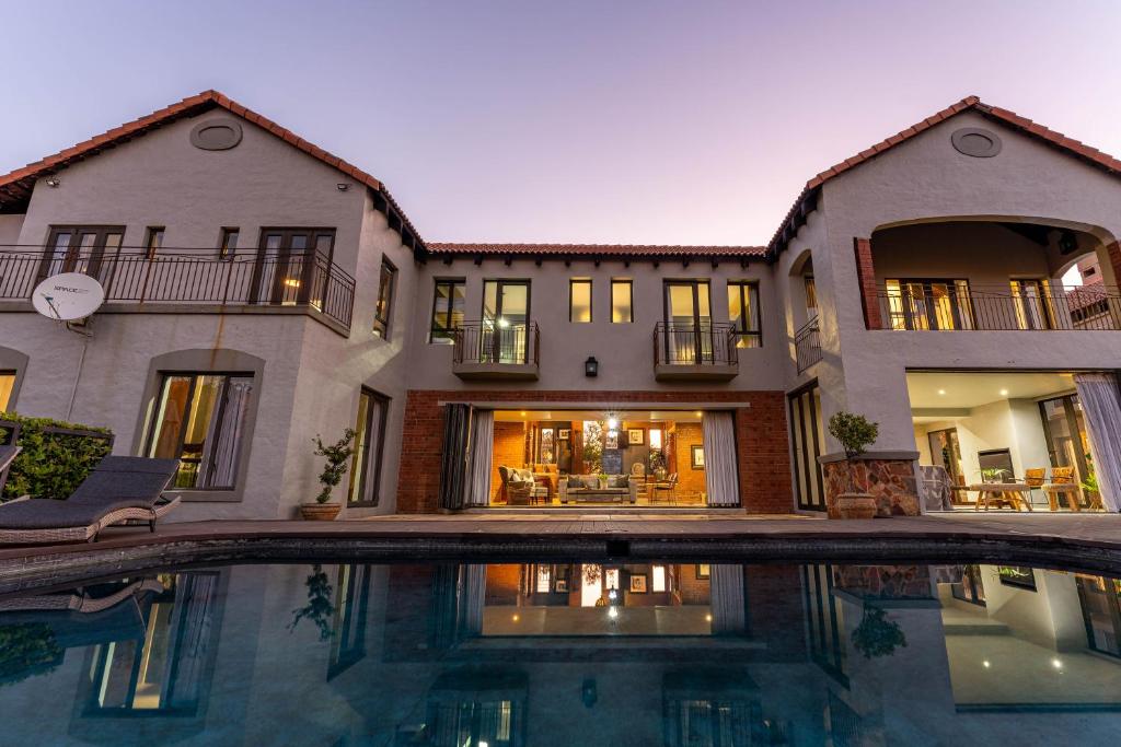 a large house with a swimming pool in front of it at Mount High Luxury Country Estate in Lydenburg