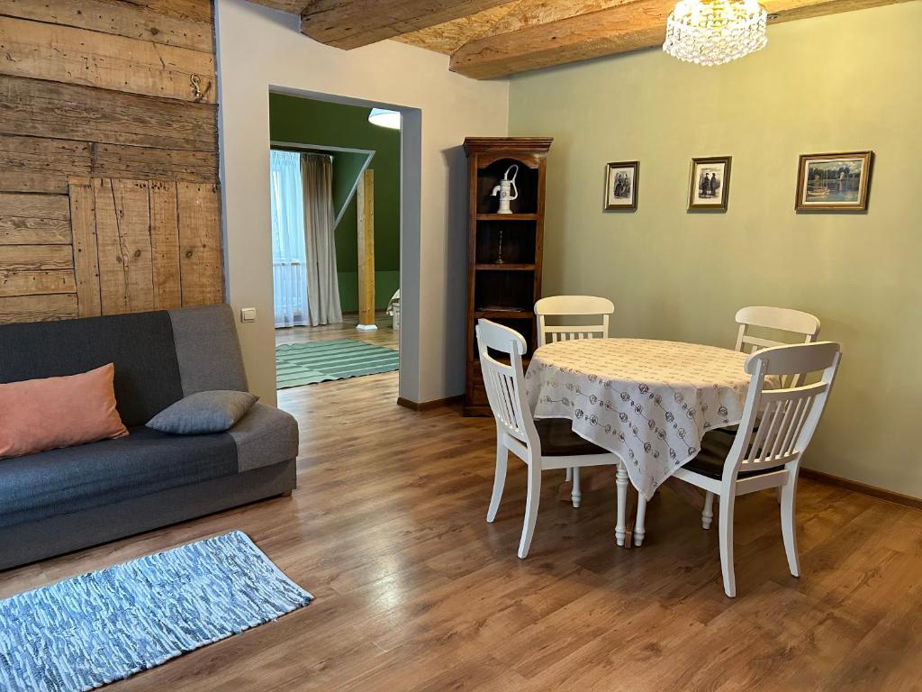 a living room with a table and chairs and a couch at A1 apartments with free parking in Rīga