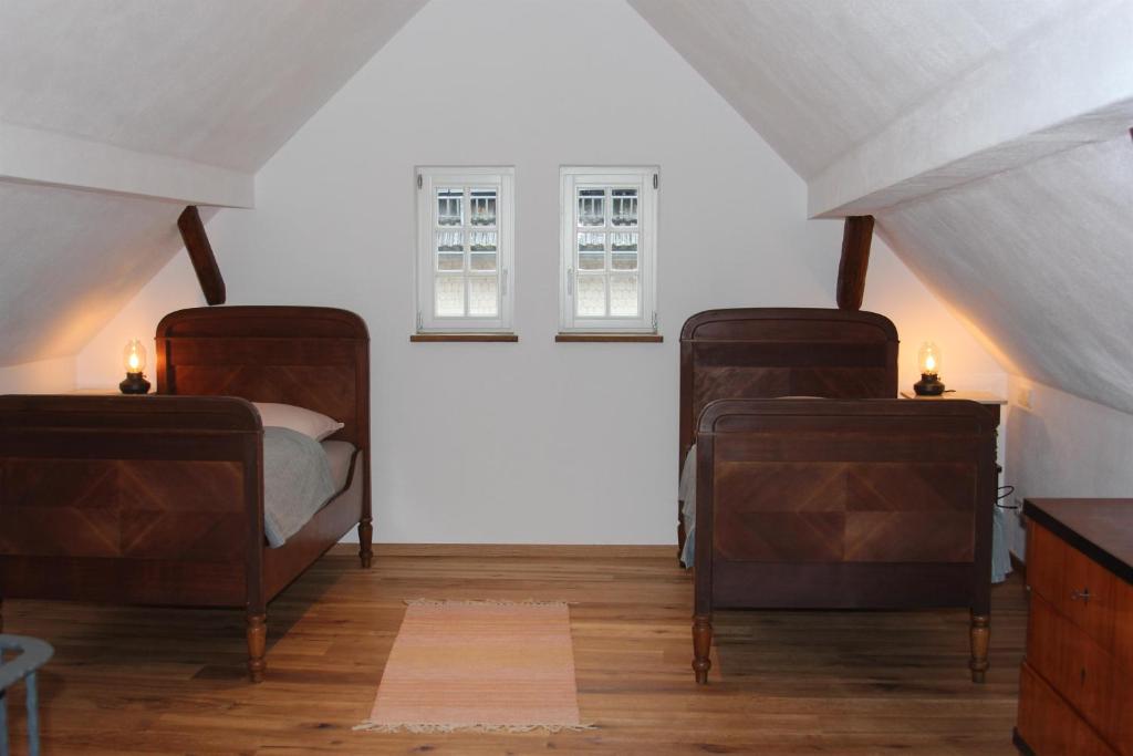 a room with two beds and two windows at Bettches Hof in Kirchhain