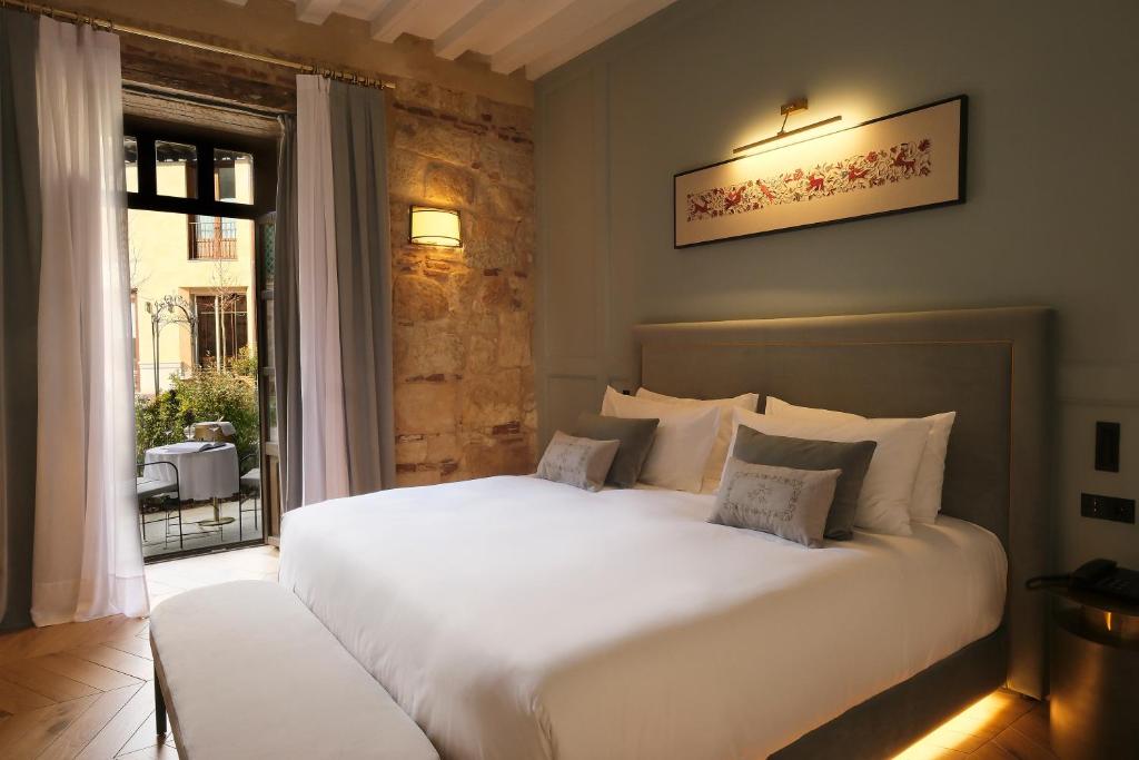 a bedroom with two white beds and a window at Eunice Hotel Gastronómico in Salamanca