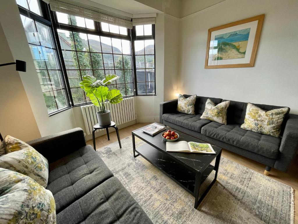 a living room with a couch and a coffee table at The Cottage Central Newcastle, 4-Star Accommodation by Tourism Northern Ireland in Newcastle