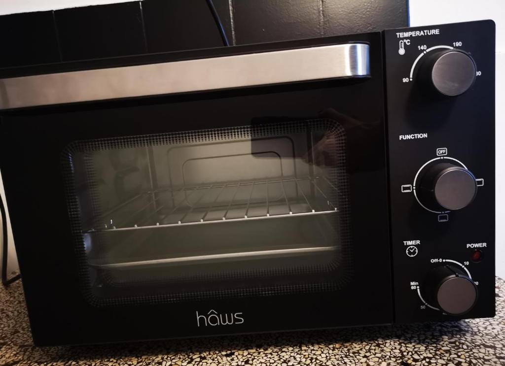 a black microwave oven with its door open at Helle´s casa in Herning