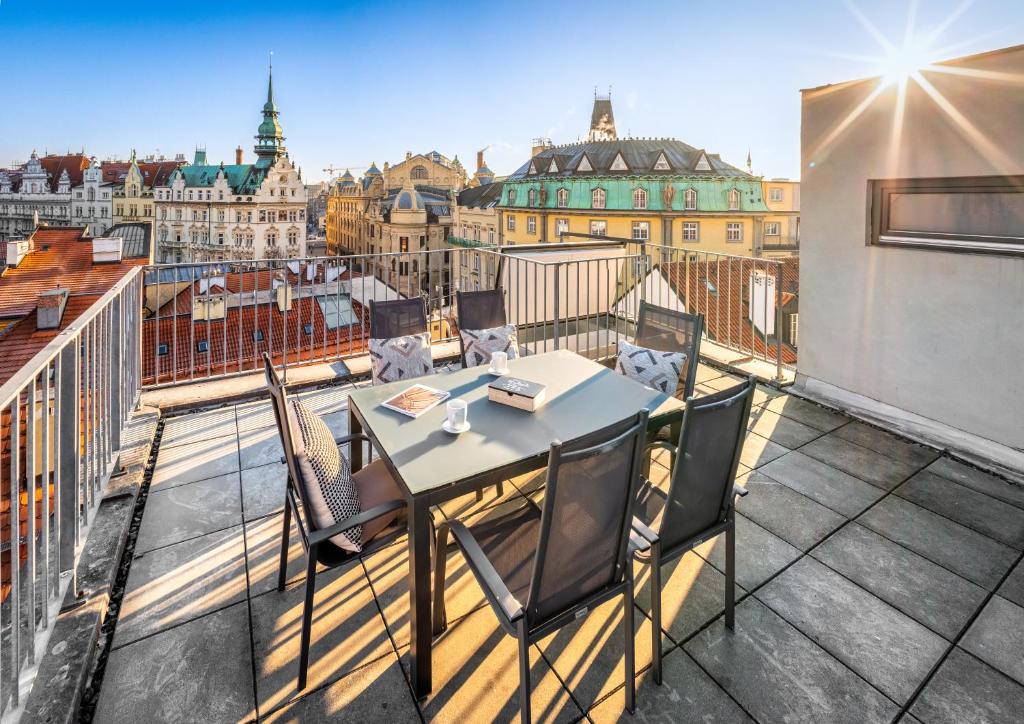 a balcony with a table and chairs on a roof at 4 Arts Apartments by Adrez in Prague