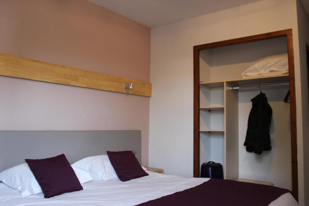 Postel nebo postele na pokoji v ubytování Hôtel Mélodie