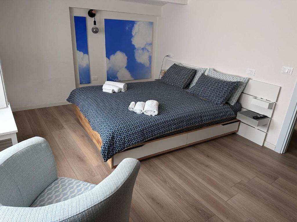 a bedroom with a bed with two towels on it at Cielo Apartment in Forlì