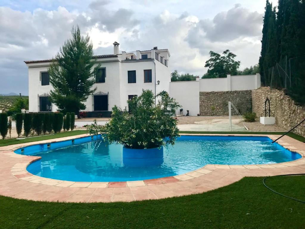 a swimming pool in front of a house at La Almedina casa Bellavista in Cazorla