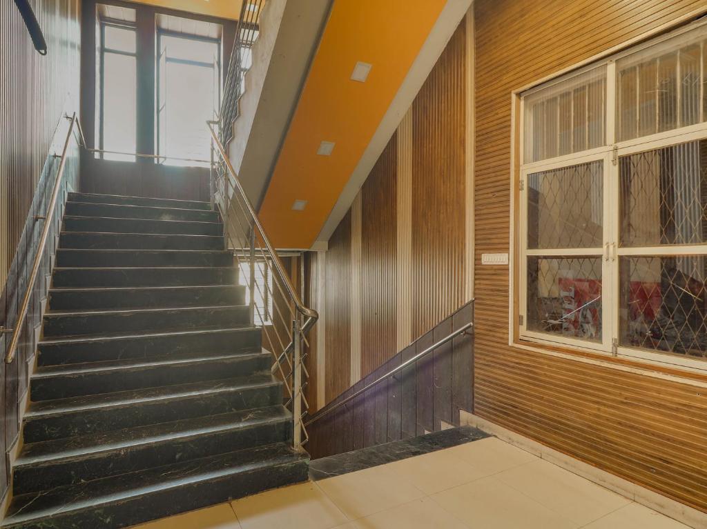 an empty staircase in a building with a window at Super OYO Flagship Hotel Diamond in Mumbai