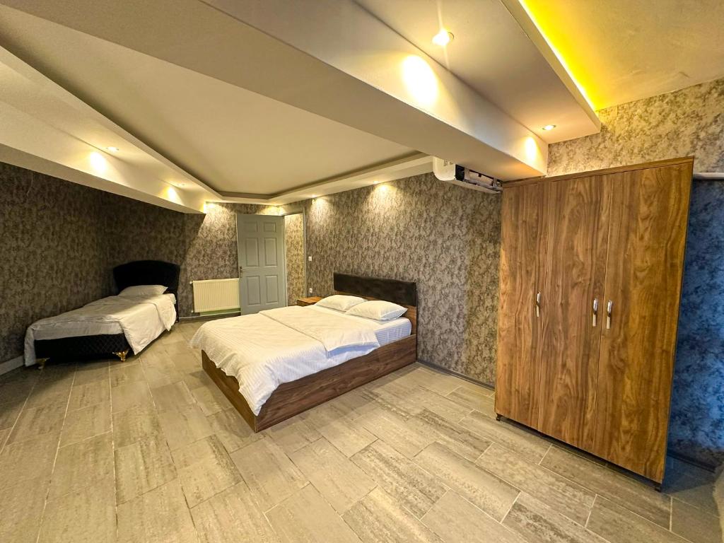 a bedroom with two beds and a fireplace at GRAND LOFT OTEL in Bursa