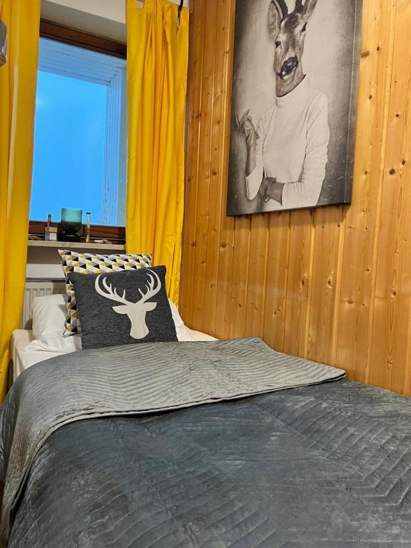 una camera da letto con un letto e una foto di un cervo appesa al muro di Monteur Handwerker Unterkunft Zimmer Mini Wohnung Bayern WLAN a Perlesreut