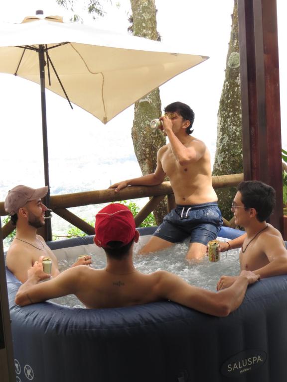 a group of men sitting in the water in a hot tub at HACIENDA EL ENSUEÑO in Floridablanca