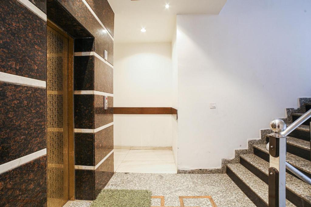 a hallway with stairs in a building at Super Townhouse 561 Hotel Hollywood Heights in Amritsar