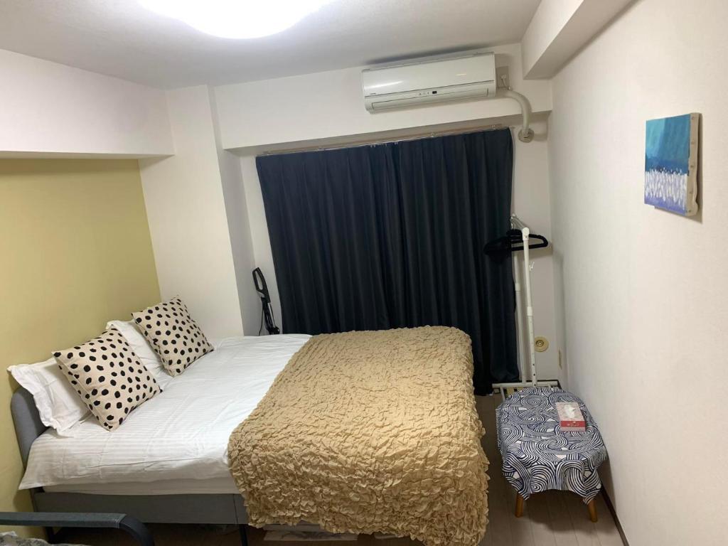 Postel nebo postele na pokoji v ubytování 诚信东新宿
