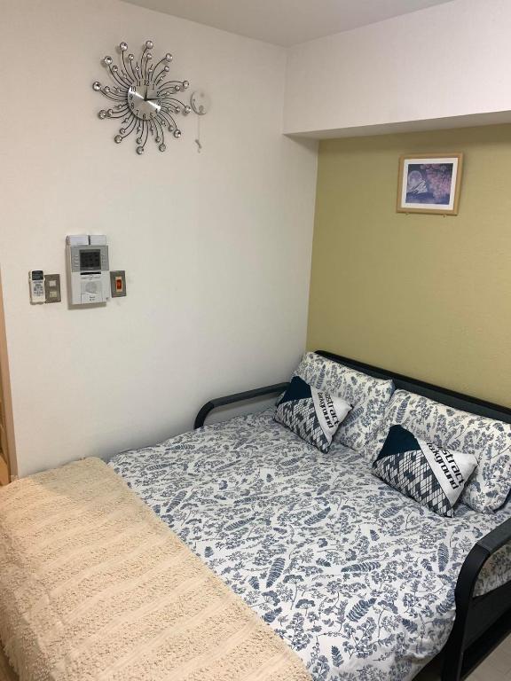 Postel nebo postele na pokoji v ubytování 诚信东新宿