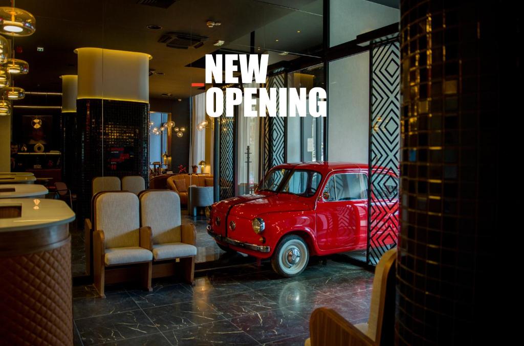 an old red car is on display in a restaurant at Radisson RED Belgrade in Belgrade