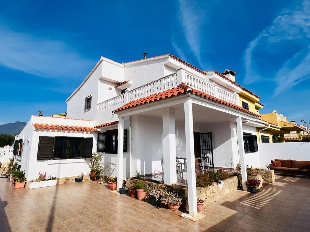 a white house with a patio in front of it at La Villa in Benicàssim