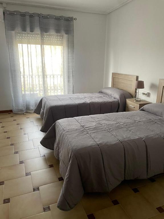 Postel nebo postele na pokoji v ubytování APARTAMENTOS LEONOR