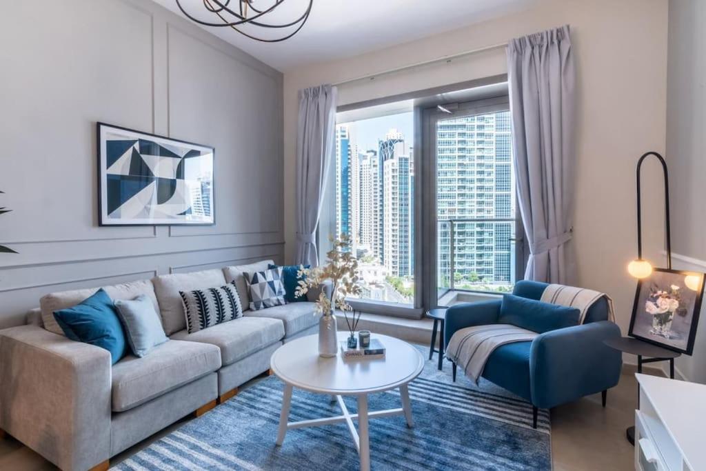 a living room with a couch and a table at GuestReady - Out of the Blue in Dubai
