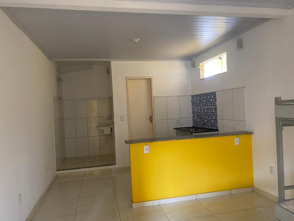 a bathroom with a yellow counter in a room at Kitnet funcional in Angra dos Reis