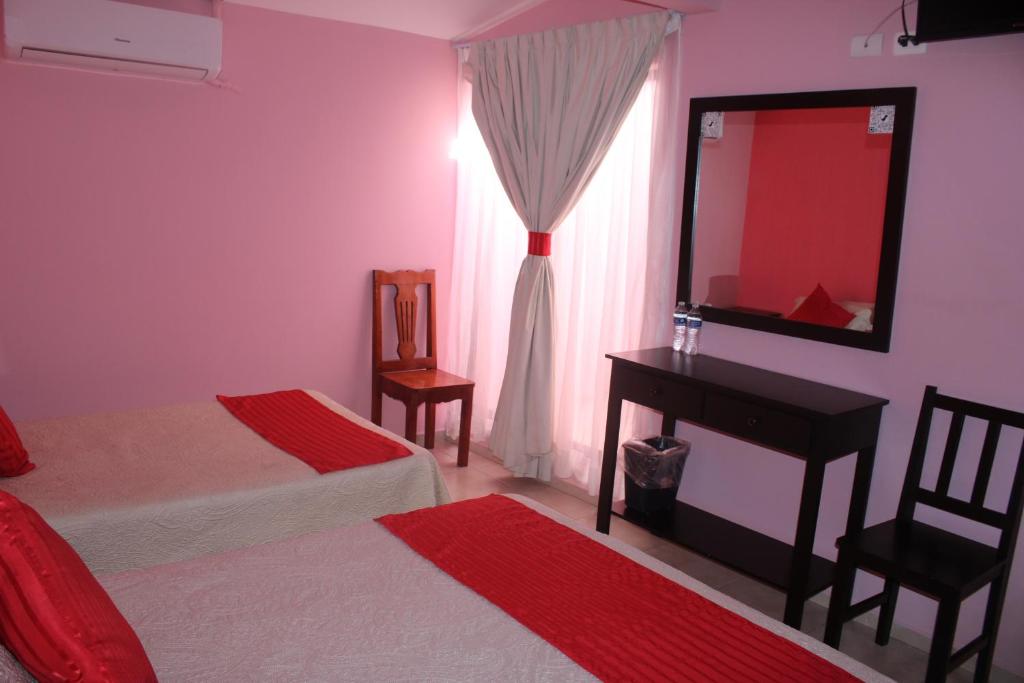 Postel nebo postele na pokoji v ubytování Hotel Boutique La Orquidea