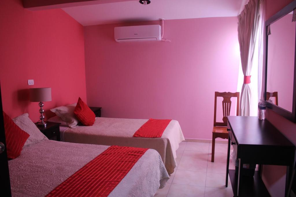 Postel nebo postele na pokoji v ubytování Hotel Boutique La Orquidea