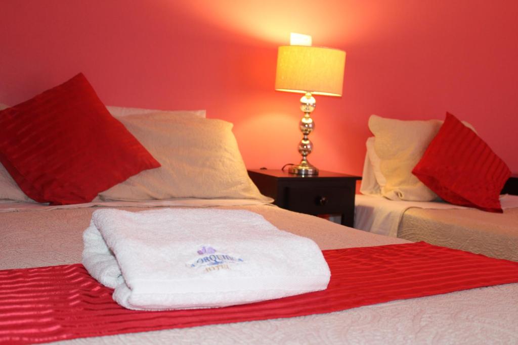 Postel nebo postele na pokoji v ubytování Hotel Boutique La Orquidea