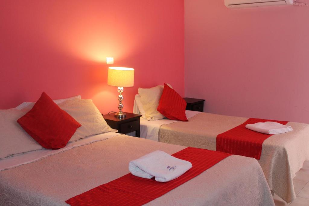Postel nebo postele na pokoji v ubytování Hotel Boutique La Orquidea