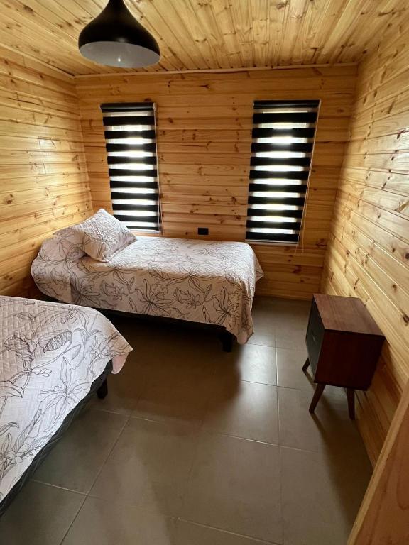 Postel nebo postele na pokoji v ubytování Cabañas Santa Elena, Curanipe
