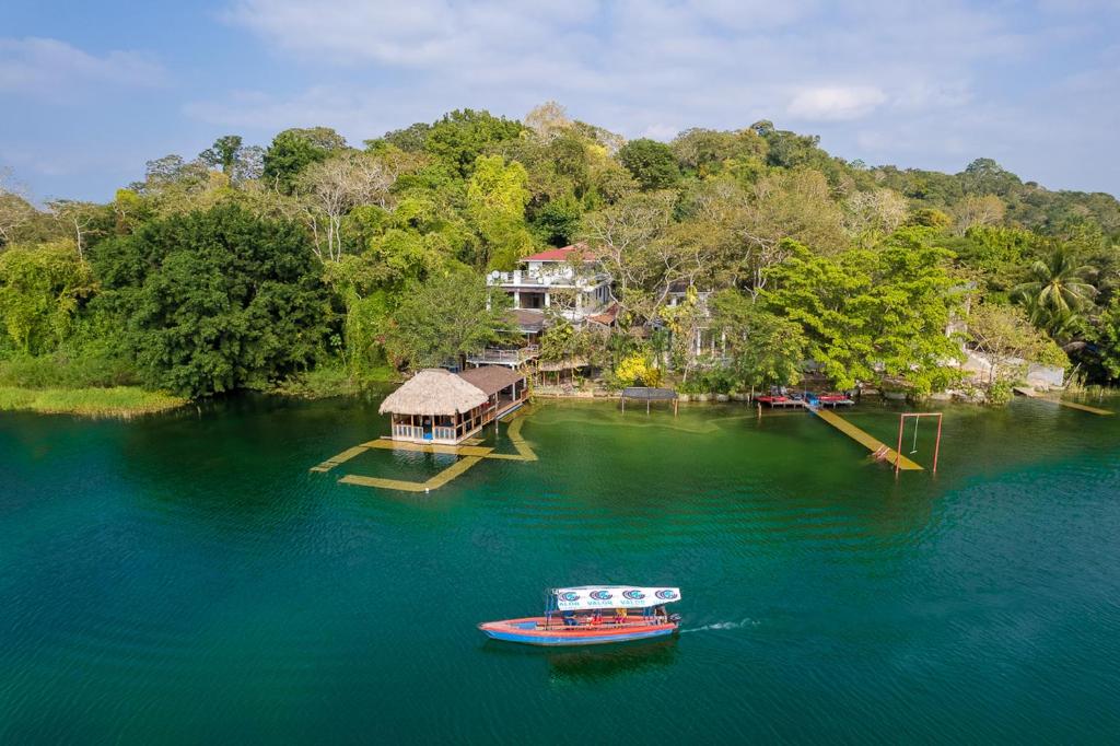 an aerial view of a house and a boat in the water at Las Luciernagas Hotel Boutique in Flores