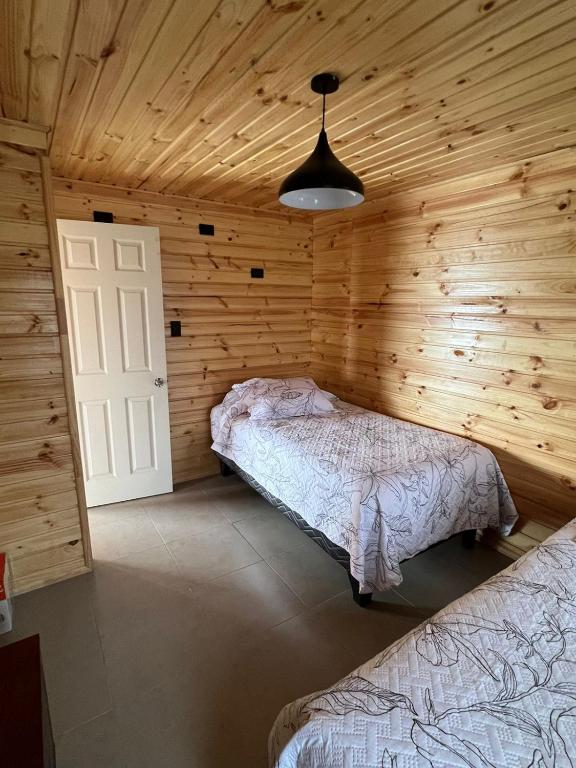 Postel nebo postele na pokoji v ubytování Cabañas Santa Elena, Curanipe